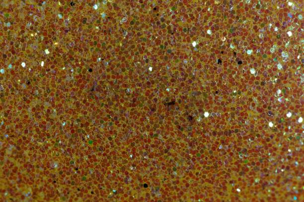 istock Glitter background made of small red fragments 903297088