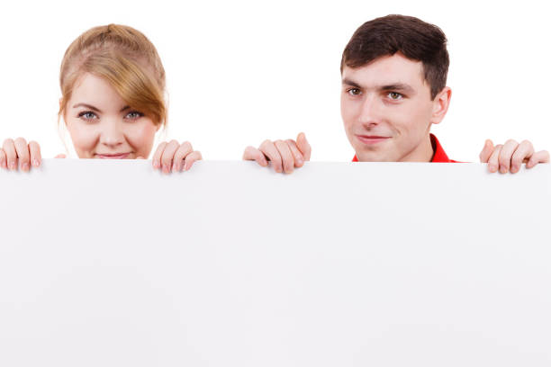 istock Couple with blank presentation board banner sign 903297366