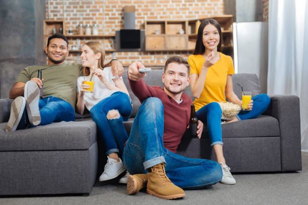 istock Two relaxing couples sitting together and watching TV 903298720