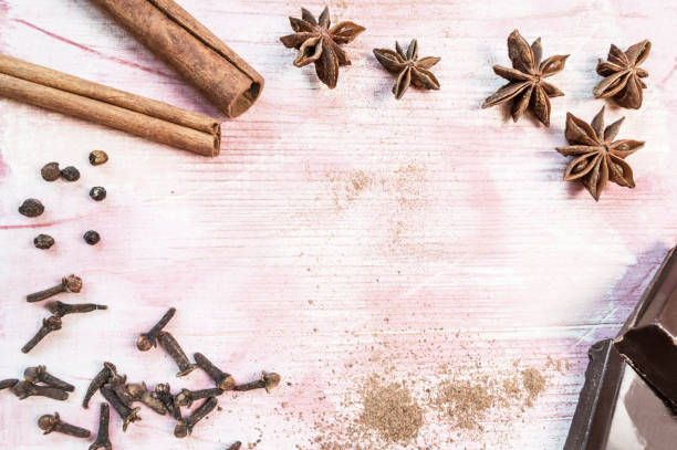 istock Star anise, chocolate, cinnamon and cloves on wooden table. 903298944