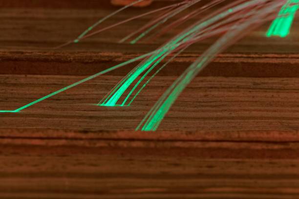 istock Glowing glass fiber cables connected with old books 903301878