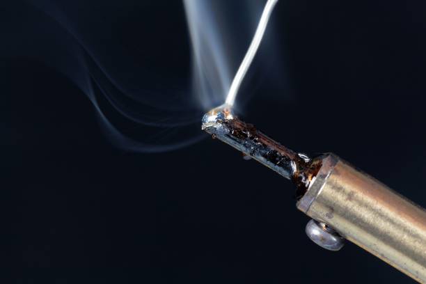 istock Melting tin on the tip of a soldering iron 903302048