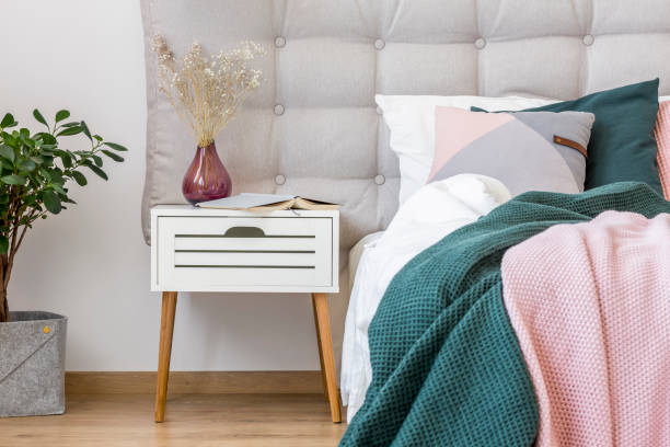 White nightstand in pastel bedroom