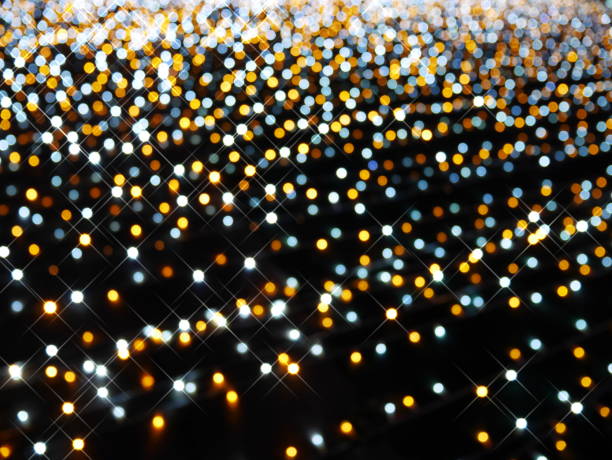 istock Luxury white, orange, yellow light bokeh on dark background 903305522