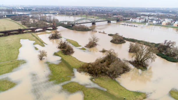 Flooded riverbanks of River Main, Germany Flooded river banks at Main River, Germany after heavy rainfall - aerial view of railroad track sluice photos stock pictures, royalty-free photos & images