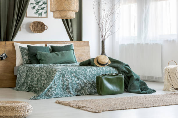 istock Suitcase in bright green bedroom 903306548