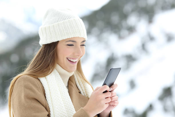 istock Lady using a smart phone in winter holidays 903309722