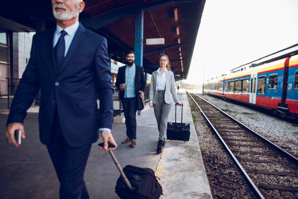 istock Business people with luggage at train station. 903310544