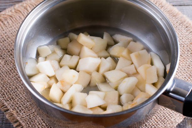 istock Pieces of pear in a saucepan. Preparing children's puree 903314094