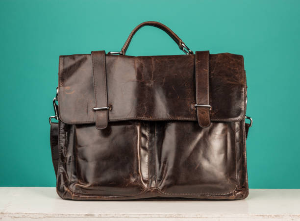 istock A vintage leather briefcase on a blue background 903317304
