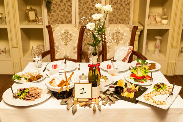 istock Restaurant white table with flowers in a bottle 903318600