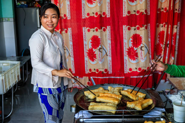 istock Vietnamese woman preparing deep fried bread stick, Mekong River Delta 903320896