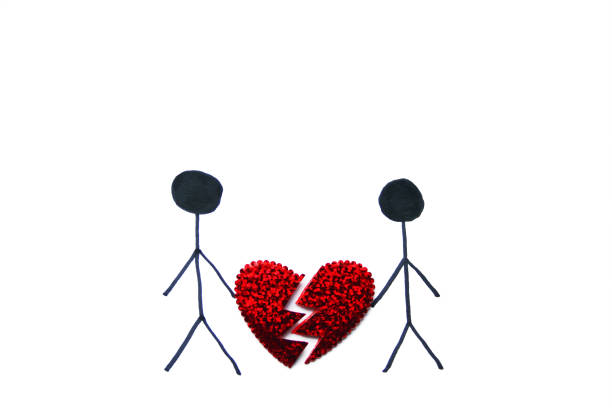 istock Two people drawing holding half of a shiny broken heart with copy space for your text or for graphic design.Top view.Concept for love and relationships,Saint Valentine's day,break up,divorce,marriage. 903322142