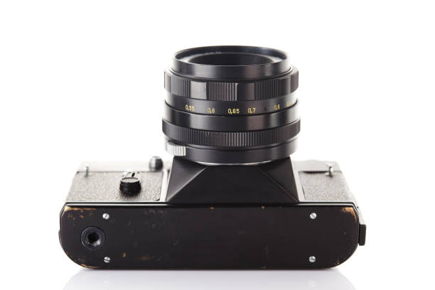 istock Old vintage film camera with lens isolated on white background 903323342