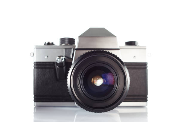 istock Old vintage film camera with lens isolated on white background 903323860