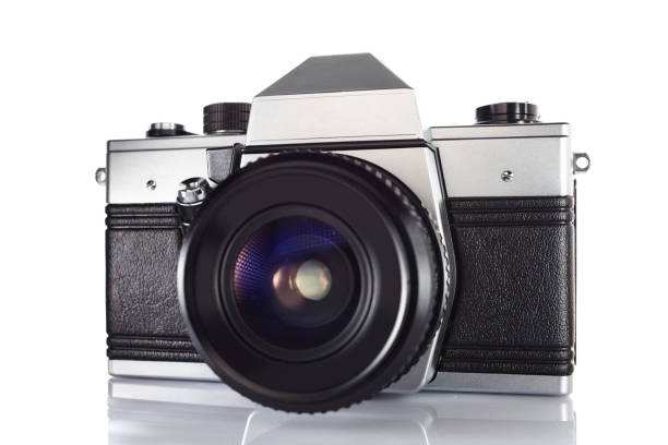 istock Old vintage film camera with lens isolated on white background 903323916