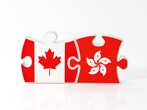 Jigsaw puzzle pieces textured with Canadian and Hong Kong flags on white. Horizontal composition with copy space. Clipping path is included.