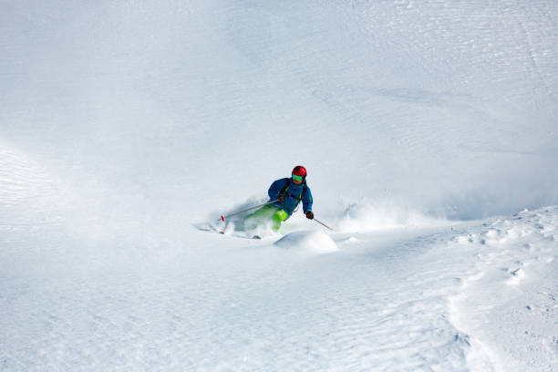 istock Man skier running downhill on sunny slope 903338030
