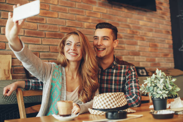 istock Young happy couple doing selfie in a cafe 903341982