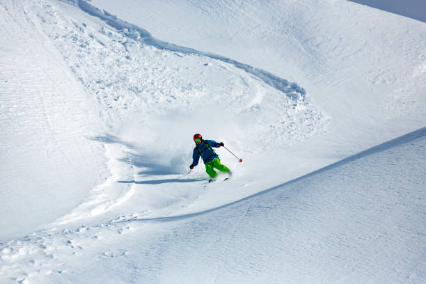 istock Man skier running down the slope in Alpine mountains 903342100