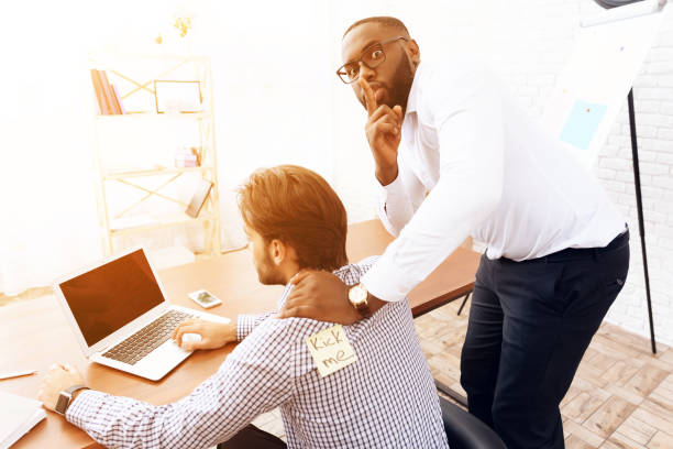 istock The men stuck a sticker on the back of another man. 903350972