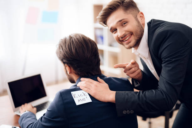 istock The men stuck a sticker on the back of another man. 903353098