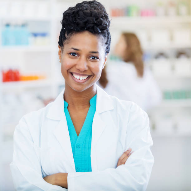istock Beautiful mid adult pharmacist smiles for camera 903353898