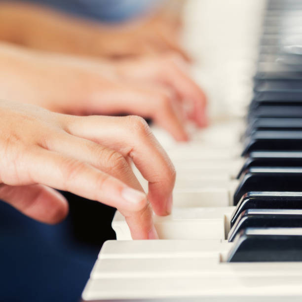 istock Two children play piano duet together 903353964