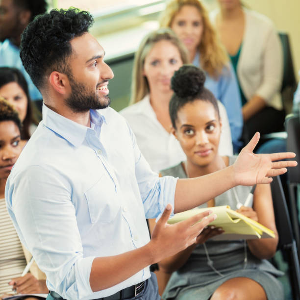 istock Cheerful man addresses audience during conference 903354100