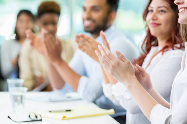 istock Businesspeople applaud conference speaker 903354128