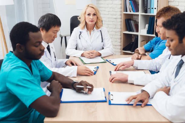 istock A group of doctors from different races is meeting at a table. 903354434