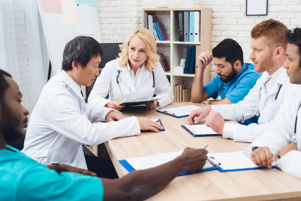 istock A group of doctors from different races is meeting at a table. 903354472