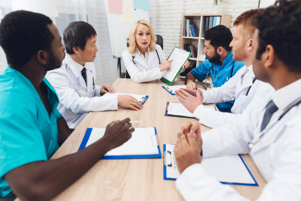 istock A group of doctors from different races is meeting at a table. 903354490