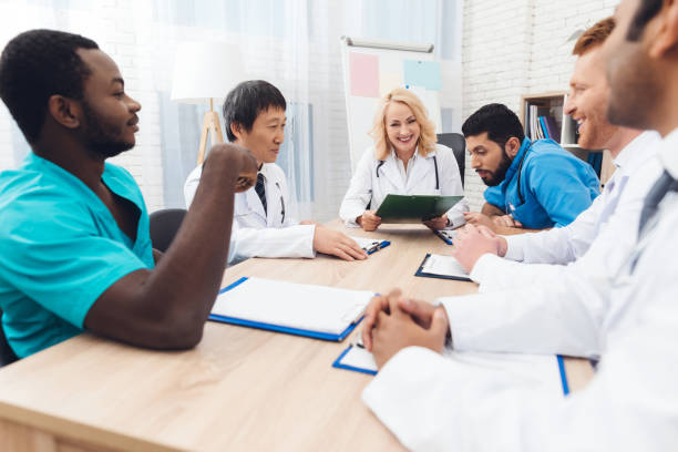 istock A group of doctors from different races is meeting at a table. 903354522
