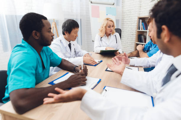 istock A group of doctors from different races is meeting at a table. 903354546