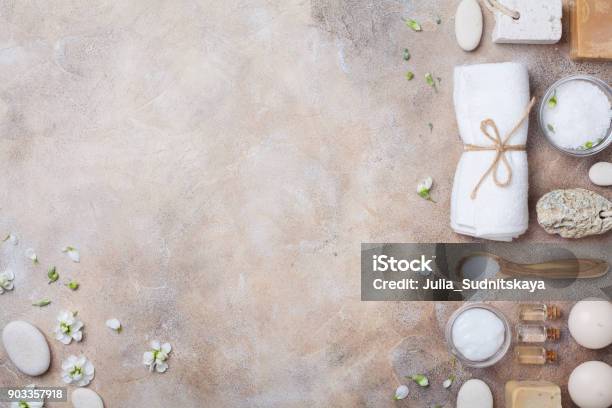 Spa And Beauty Conceptual Stone Background From Handmade Body Care And Aromatherapy Supplies Decorated Flowers Top View Stock Photo - Download Image Now