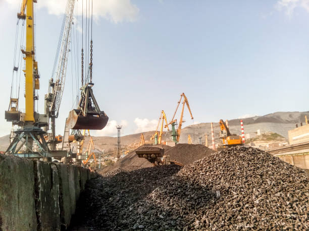 Cargo industrial port, port cranes. Loading of anthracite. Transportation of coal. Heap of coal Cargo industrial port, port cranes. Loading of anthracite. Transportation of coal. Heap of coal. portage valley stock pictures, royalty-free photos & images