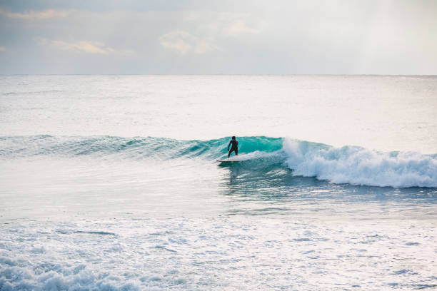 istock Surfer on blue wave. Winter surfing in ocean 903362534