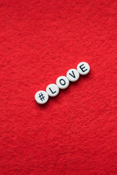 love letter on a red background, letters in the form of plastic buttons with a sign hashtag - splitup imagens e fotografias de stock