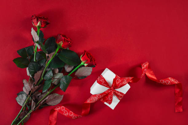istock Top view fresh red rose flower and gift box on red deck with emp 903369612