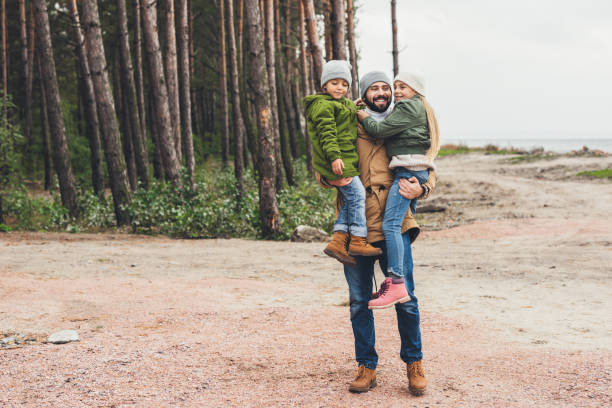 istock father and kids having fun on nature 903370034