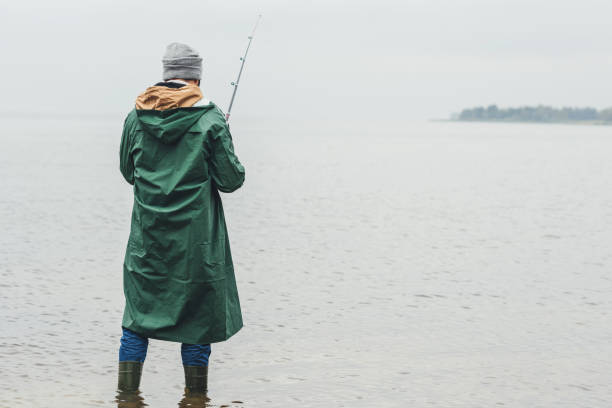 istock man fishing on rainy day 903373856