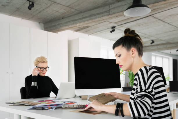 istock Senior and young interior working in the office 903378712