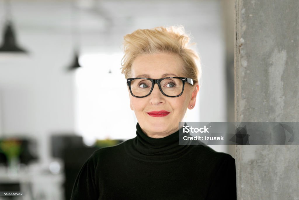 Portrait of elegant senior businesswoman in the studio Portrait of elegant senior businesswoman standing in her office. Close up of face. Human Face Stock Photo