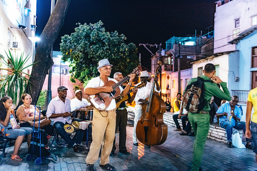 Santiago de Cuba, Cuba - February 21, 2017: old musicians playing in the streets of Santiago de Cuba at night