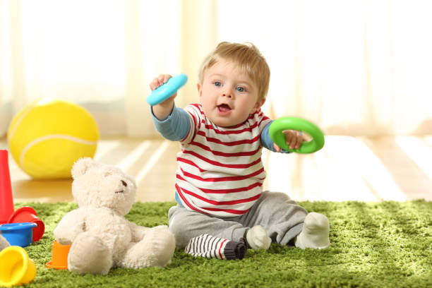 istock Baby playing with toys on a carpet 903388754