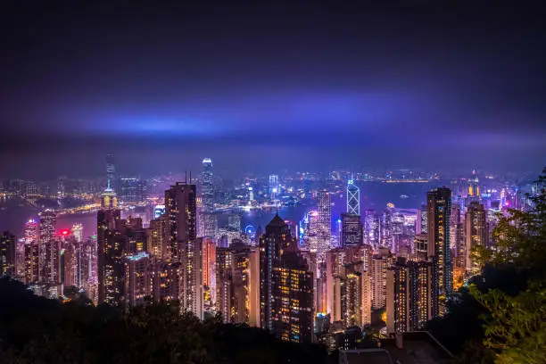 Hong Kong harbour by night from Victoria Peak. Colorful skyscrapers financial districts. Night scene with neon lightings