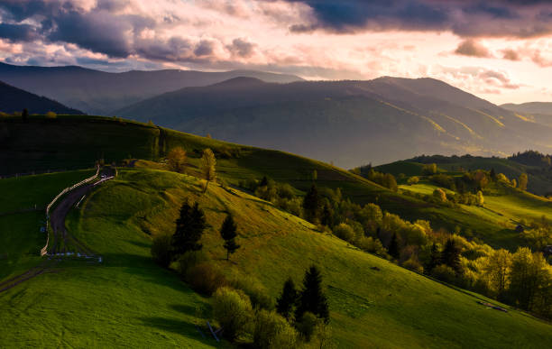 istock countryside road through grassy hills at sunset 903389404