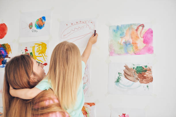 istock Mother and daughter drawing together 903389704