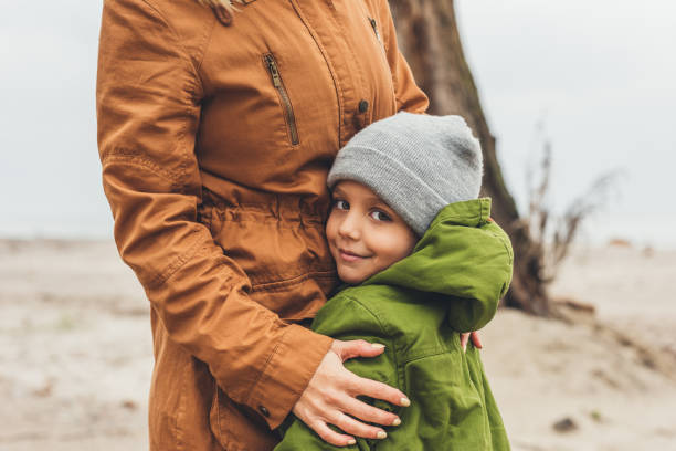 istock mother and son embracing outdoors 903391000